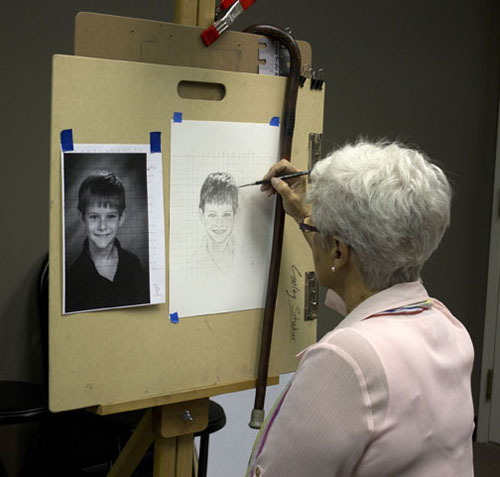 Judy working on a portrait of one of her grand children